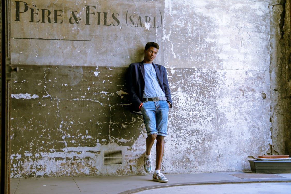 Man Standing in Suit Jacket and Jean Shorts