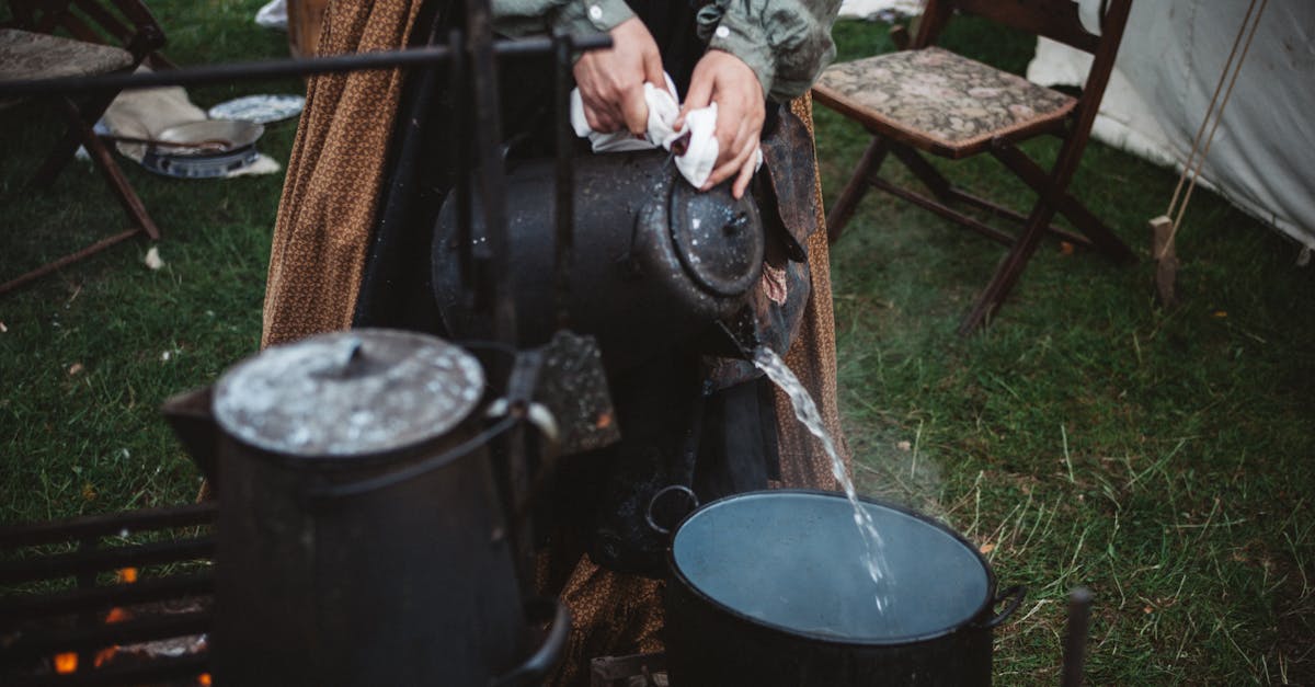 Person Pouring Water on Cooking Pot