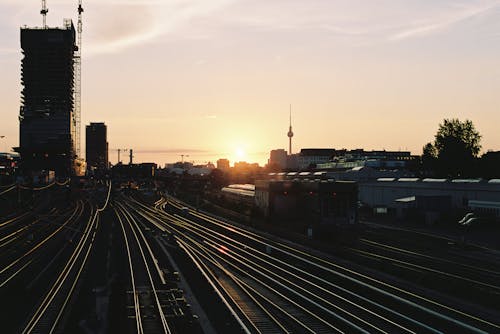 A train tracks with a sunset in the background