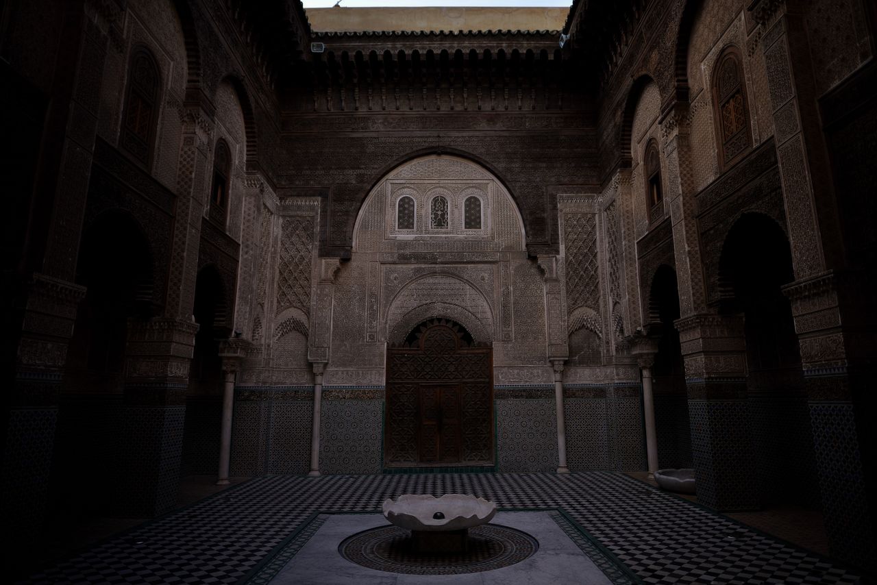 an elegant courtyard featuring traditional arches and a central founta
