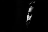 迷人的黑白肖像在深深的阴影中突出了一个人深思熟虑的表情