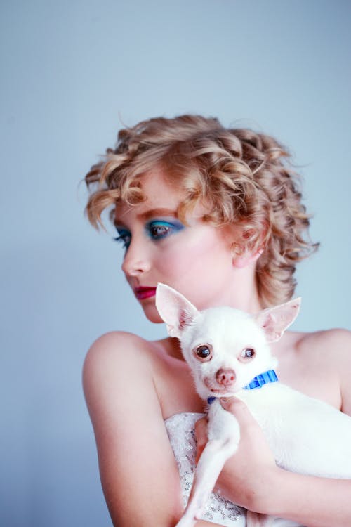 Woman Holding White Dog