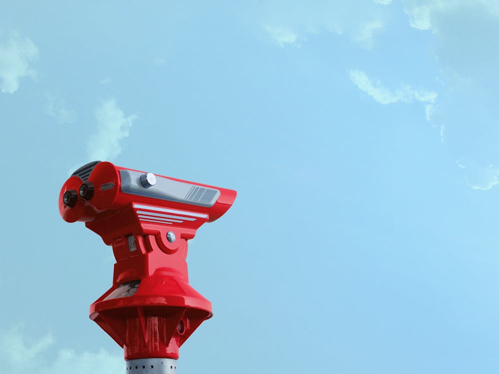Red Theodolite Under Blue Sky and White Clouds