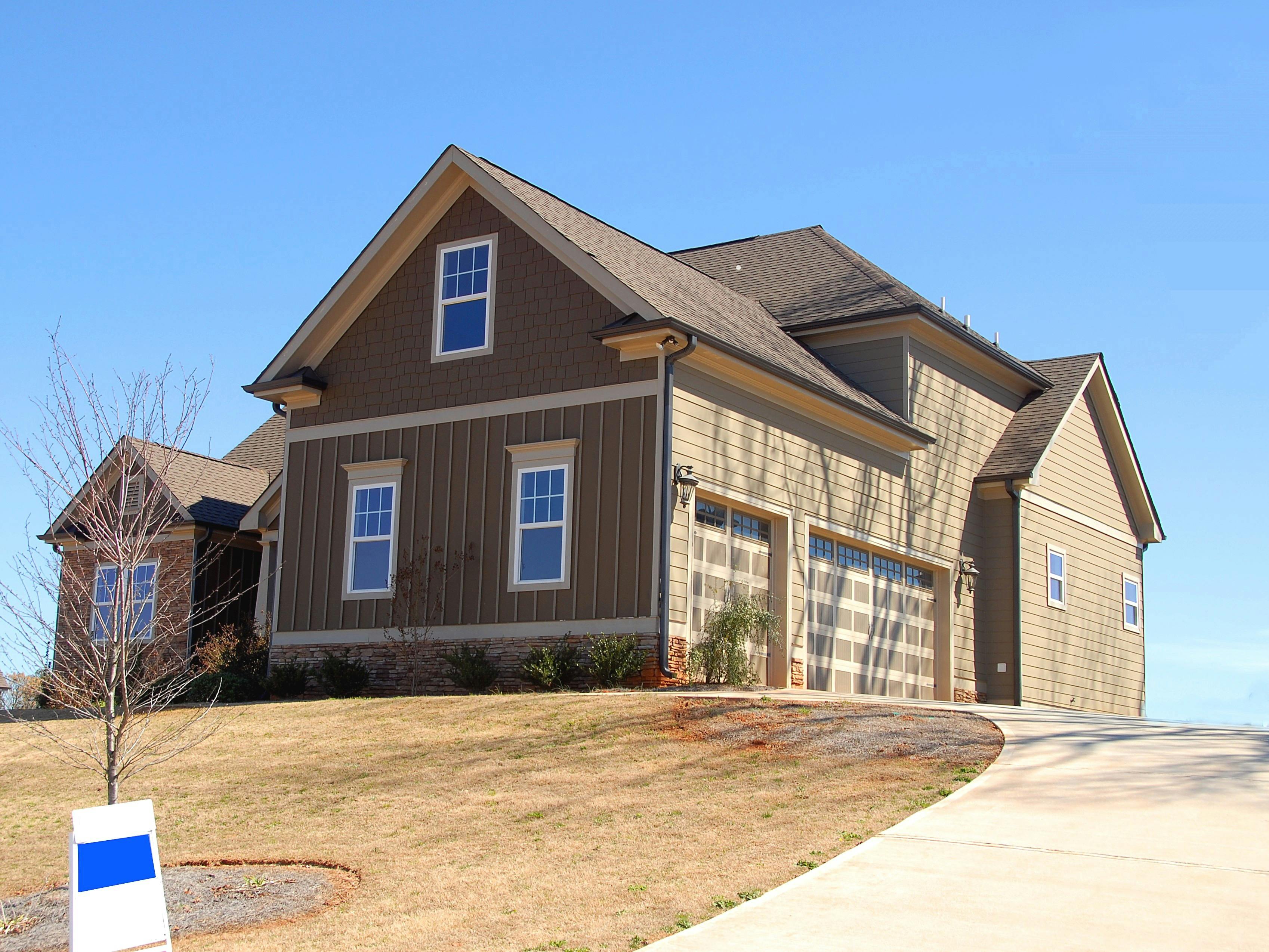 brown and beige wooden house under blue sky