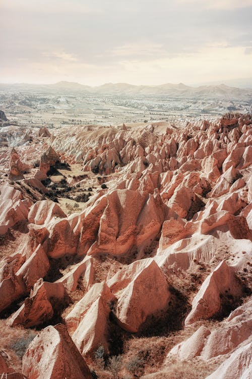 Brown Rocky Formations Under a Cloudy Sky