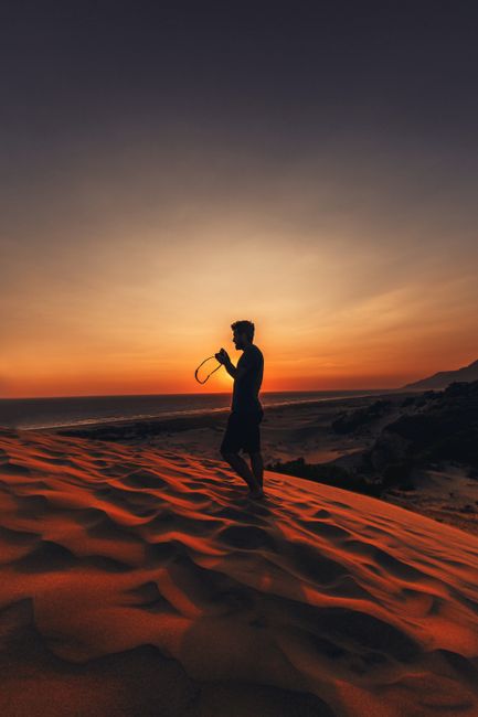 Beautiful silhouette of a man during sunset on sand dunes in Antalya, Turkey, capturing serene beauty.