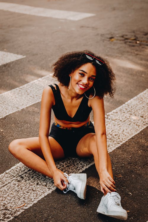 Woman Sitting On Pedestrian Lane