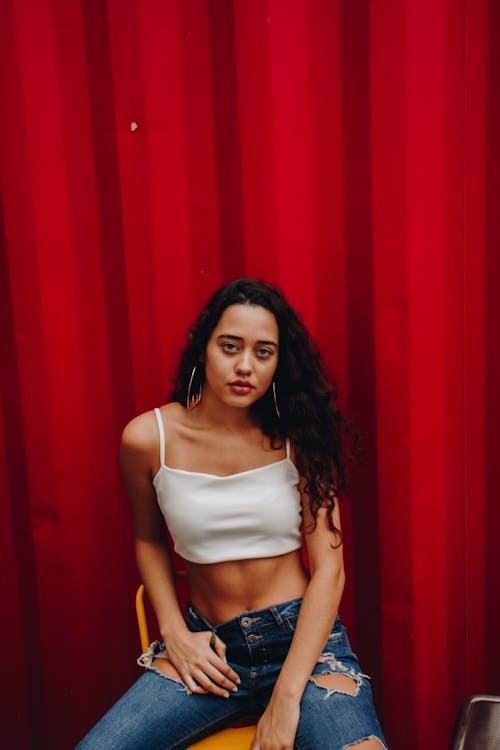 Woman Sitting Near Red Wall