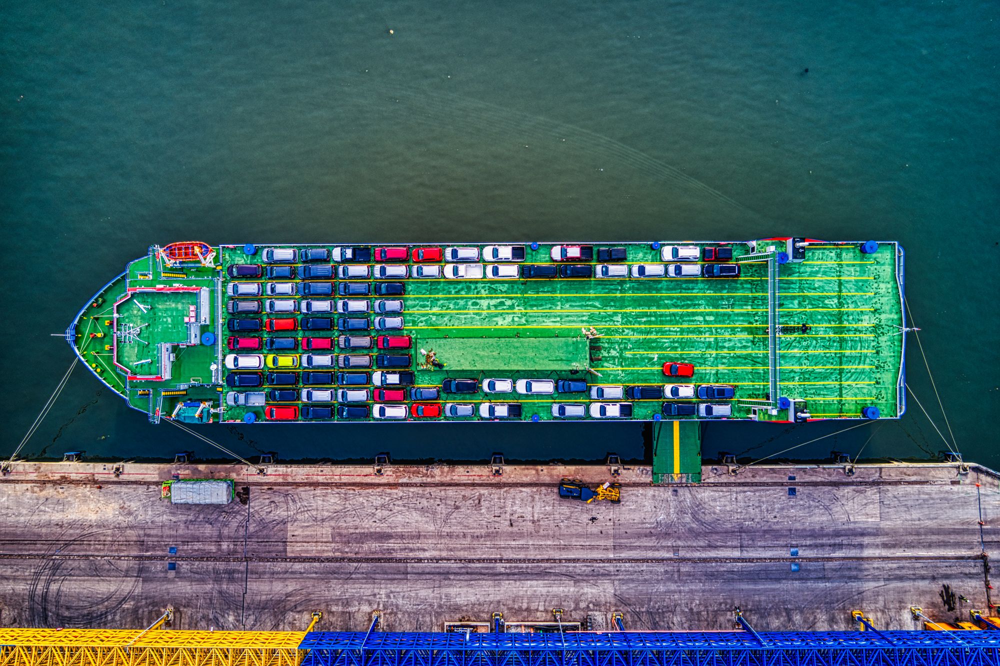 A car carrier ship loaded with vehicles directly illustrates automotive trade and the commercial stakes of export access.