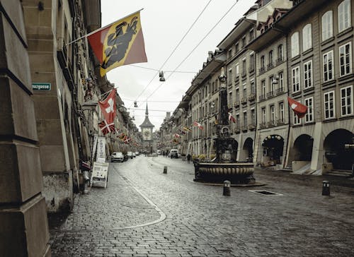 A city street with flags flying in the air