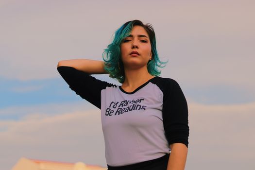 Woman Wearing Black And White Shirt Holding Her Hair