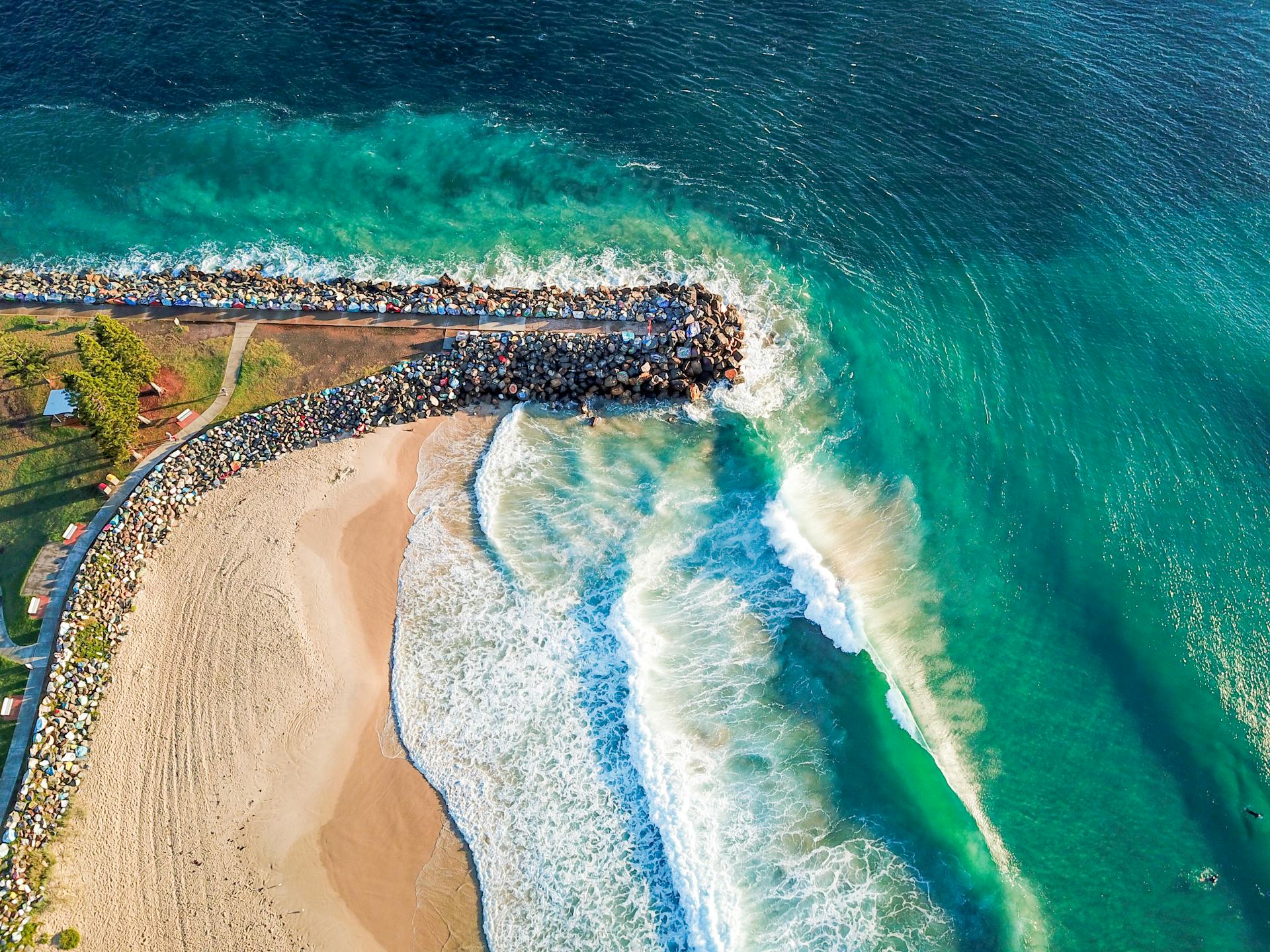 Breathtaking aerial view of waves crashing on Port Macquarie coastline in NSW, Australia.