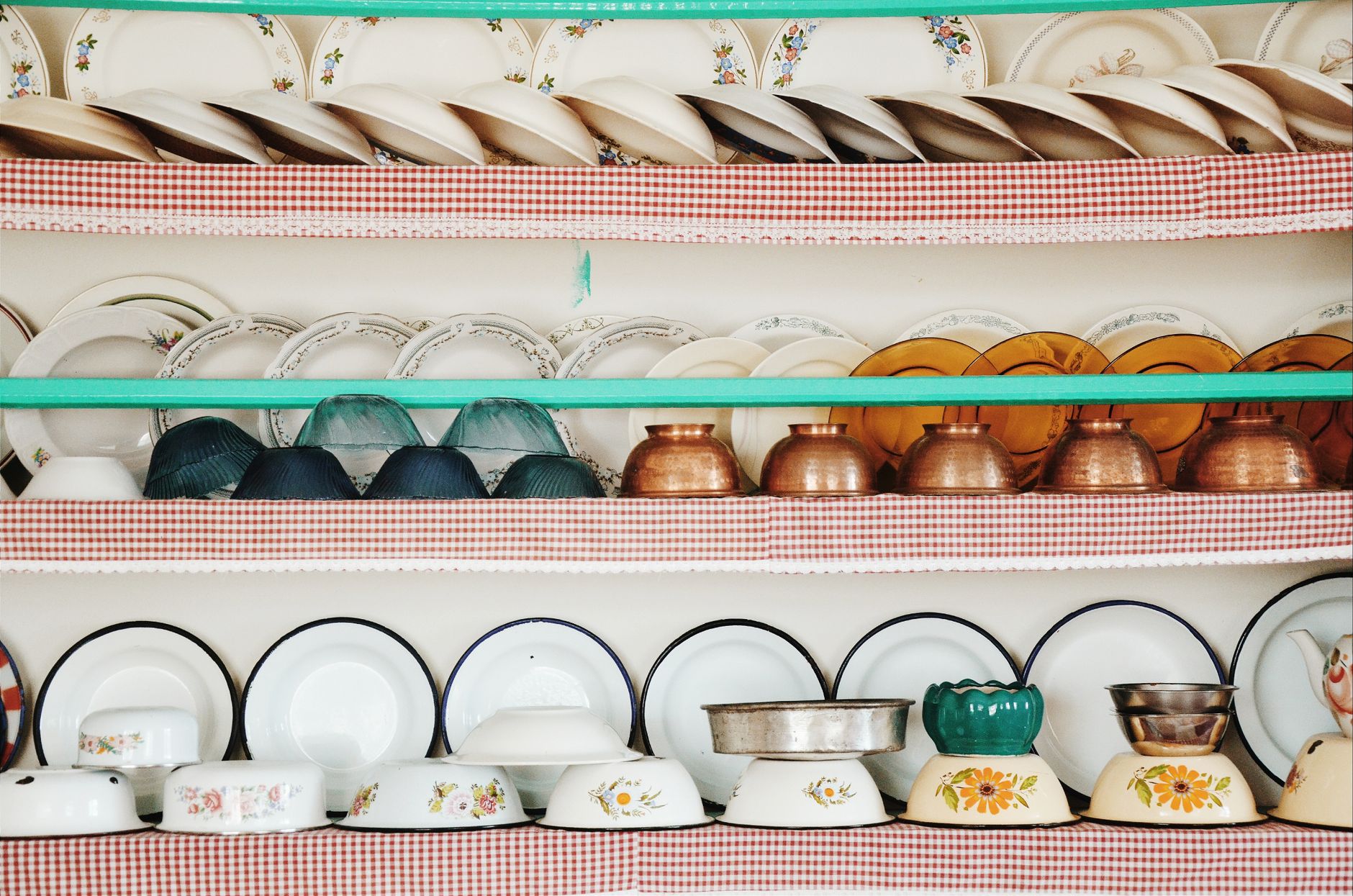Collection of colorful vintage dishware neatly stacked