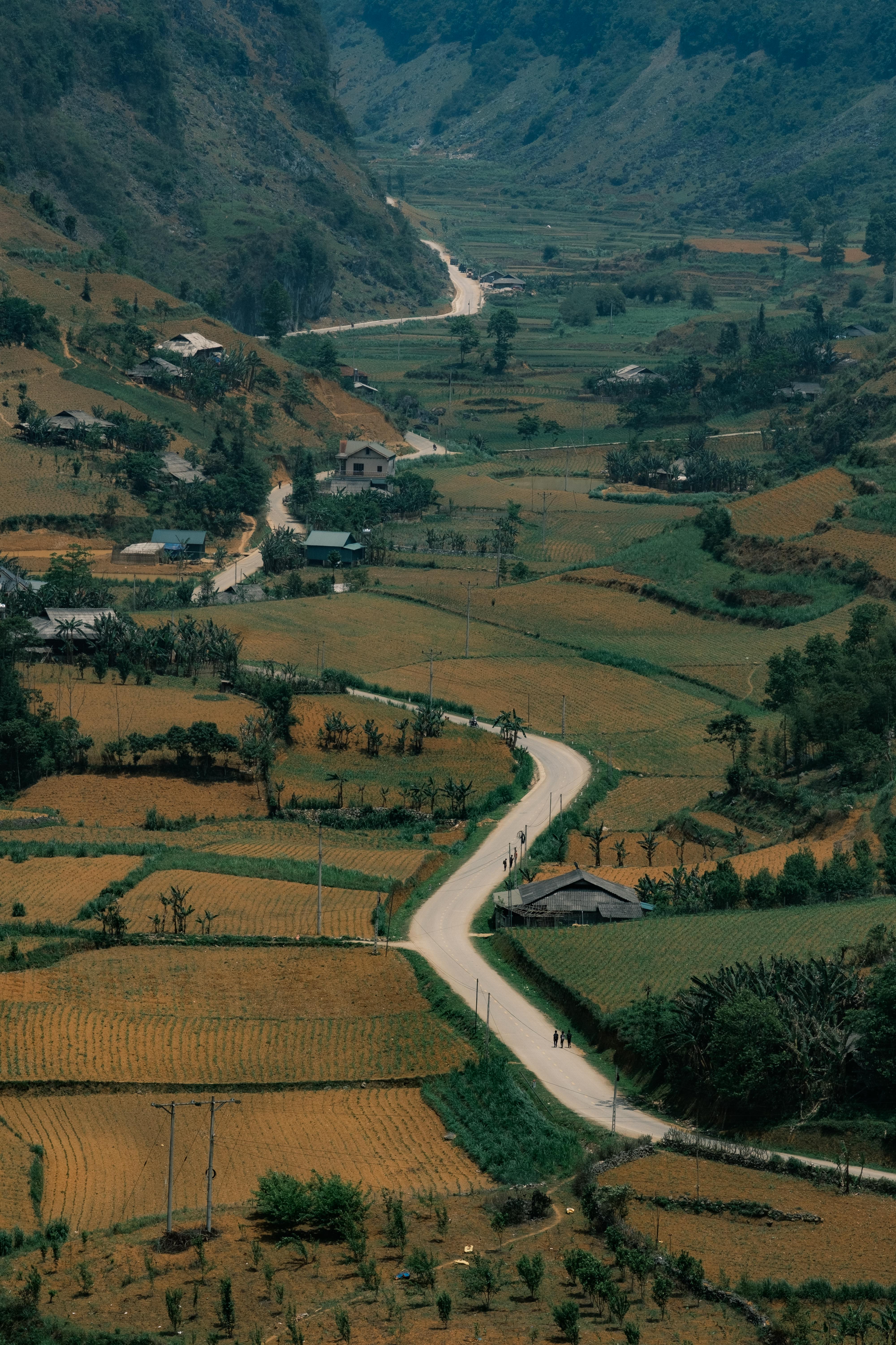 Breathtaking aerial view of winding roads and fields in rural Cao Bang, Vietnam.