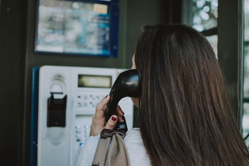 Shallow Focus Photo Of Person Using Telephone