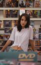 Woman Wearing White Shirt Standing Near Rack