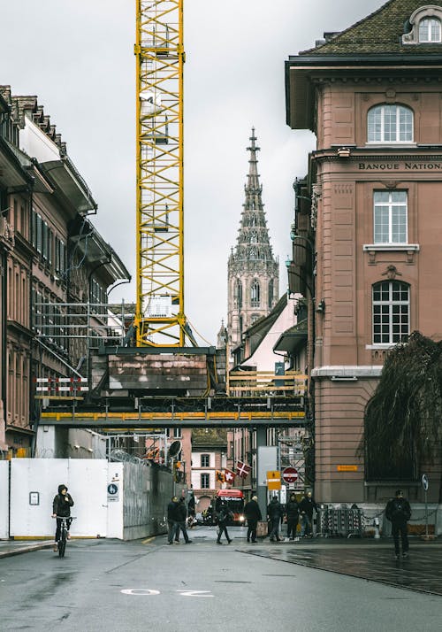 A city street with a crane and buildings