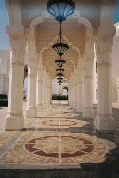 The columns of a mosque are lined with lamps