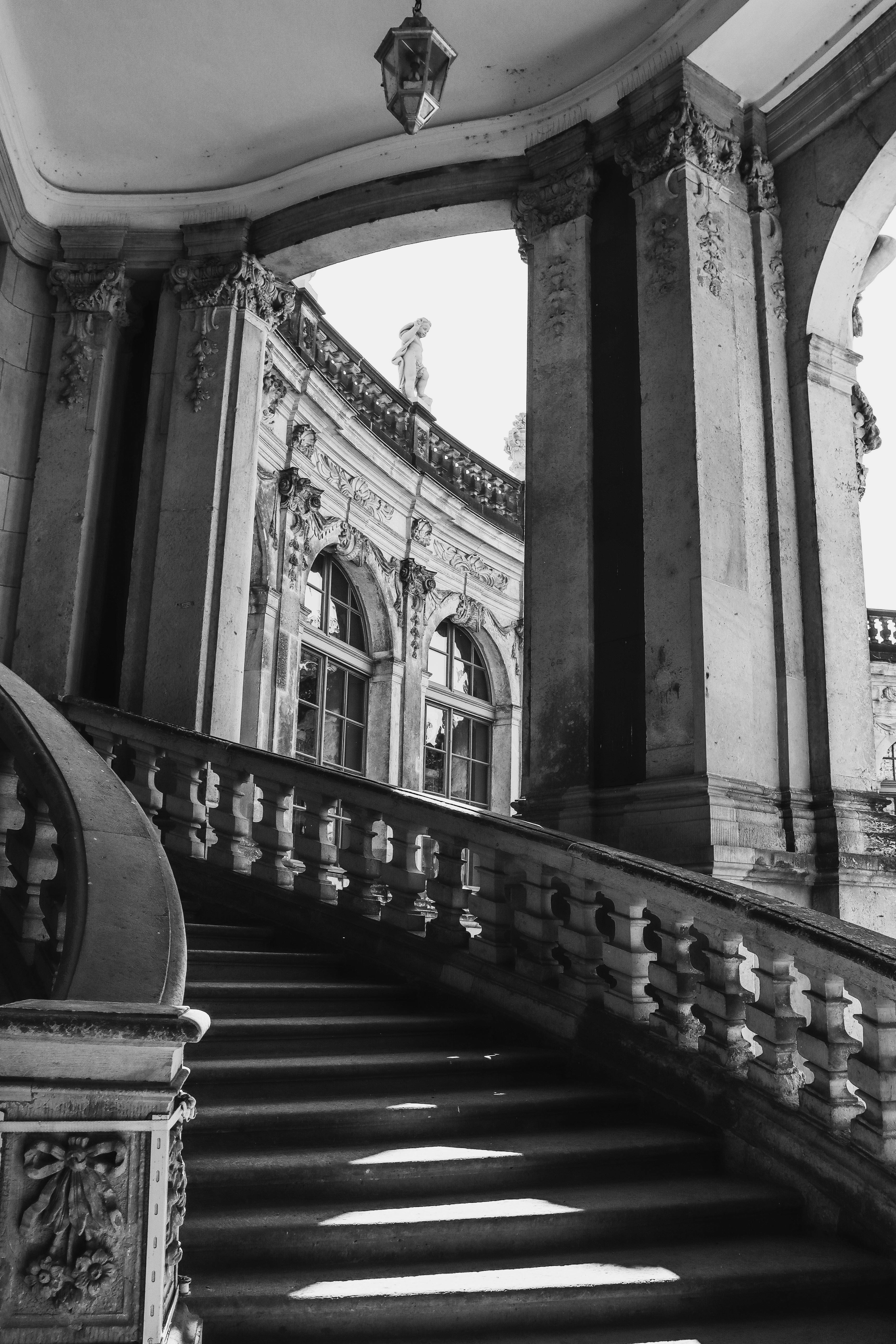 Intricate Baroque architectural details captured in black and white, showcasing a majestic staircase.