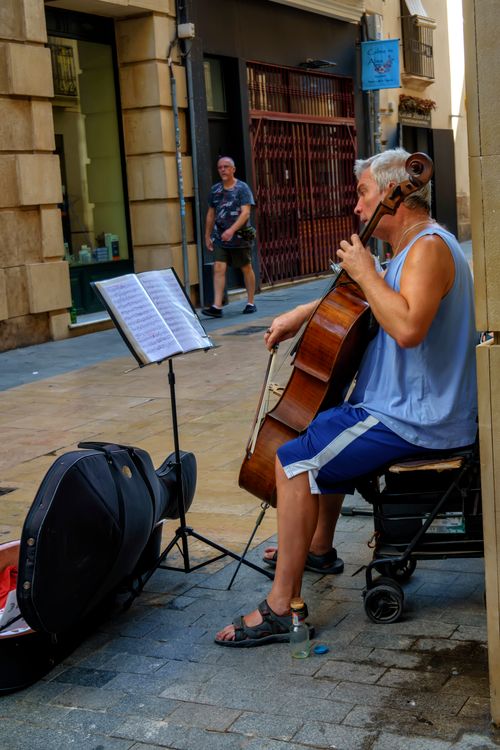Free Elderly busker playing cello outdoors on a sunny day in Valencia, Spain. Stock Photo