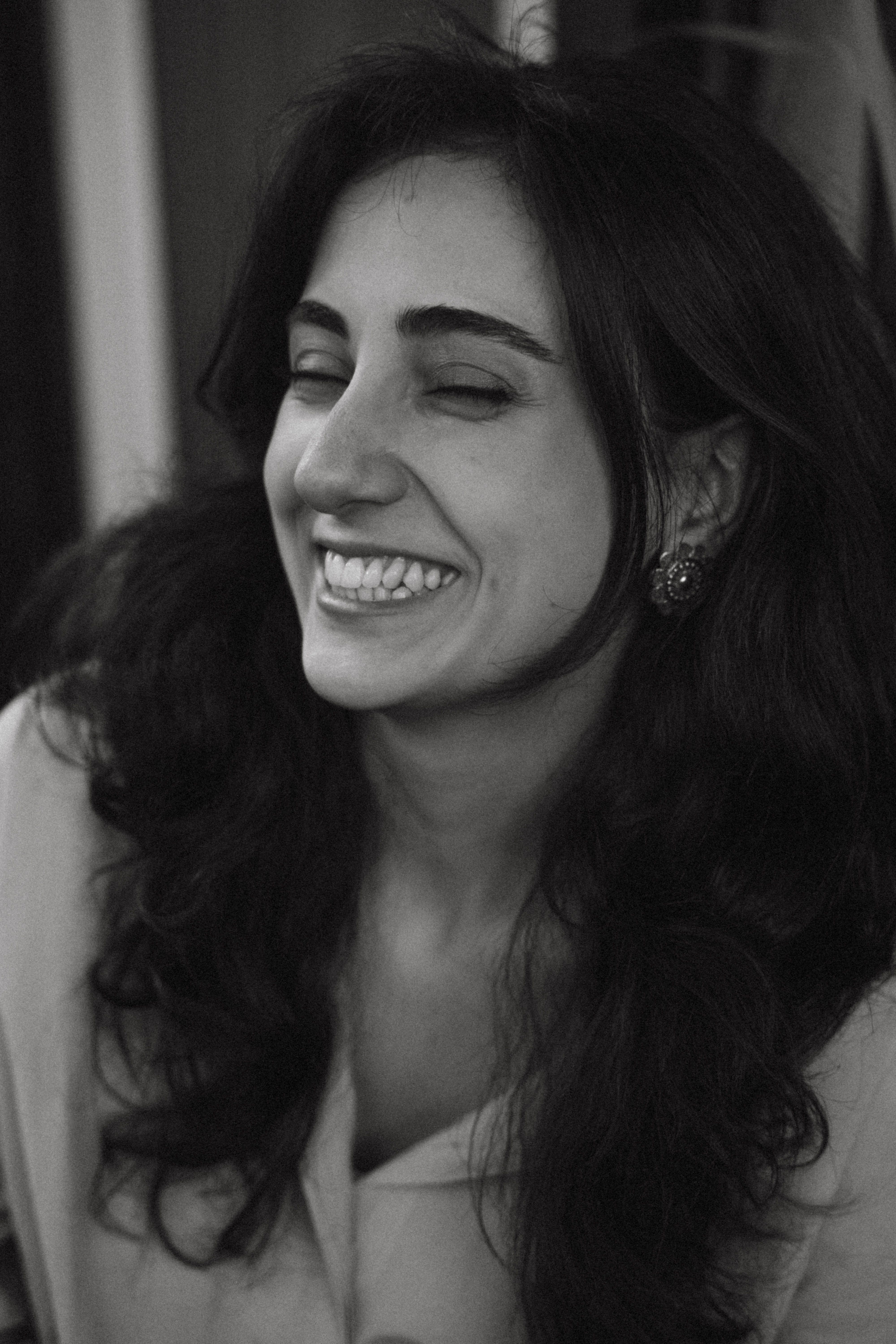 Black and white portrait of a happy young woman smiling in Baku, Azerbaijan.