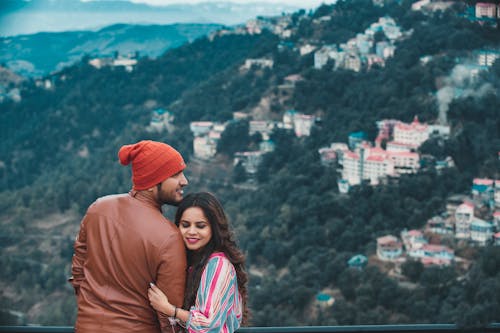 Woman Hugging the Arms of Man