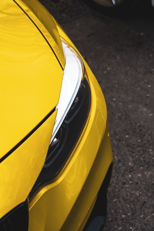 Free Detailed view of a yellow sports car highlighting the modern headlight and sleek design. Stock Photo