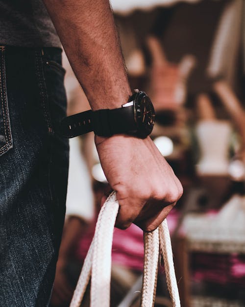 Man Wearing Black Wristwatch on Right Hand Holding Bag