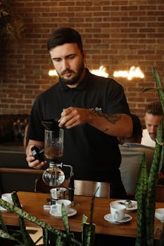 A barista skillfully prepares coffee using a siphon at a Rio de Janeiro café.