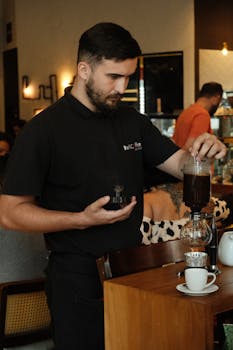 Barista making pour-over coffee at a cozy café in Rio de Janeiro.