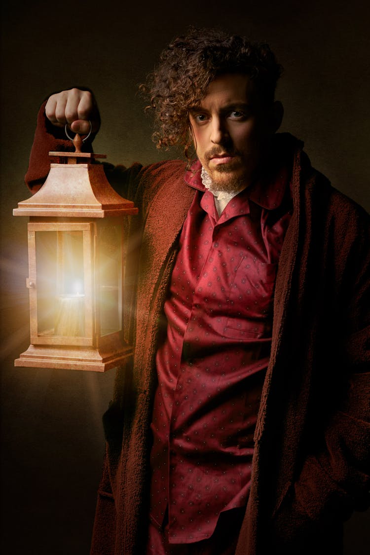 Photo Of Man Holding Lamp