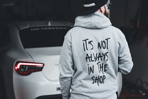 A man wearing a hoodie that says it's not always in the shop