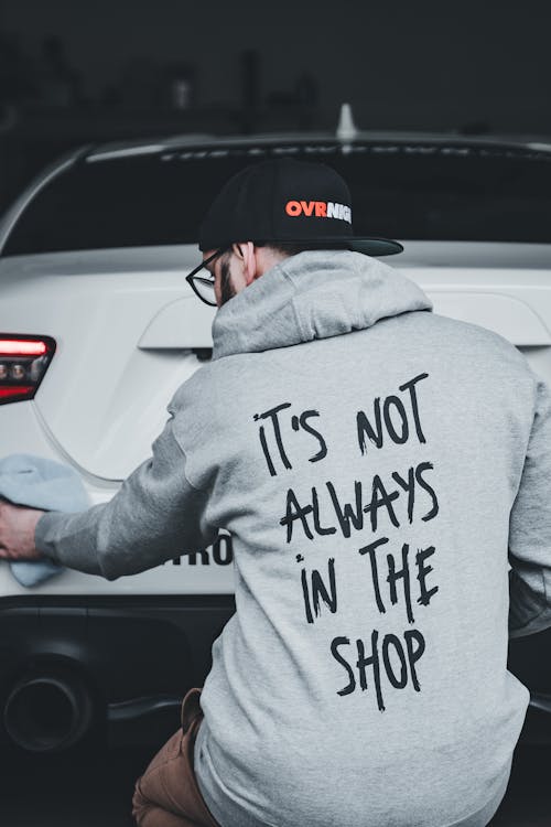 A man wearing a hoodie that says it's not always in the shop