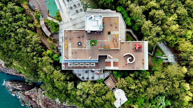 Stunning aerial view of a vibrant rooftop surrounded by greenery, located in Busan, South Korea.