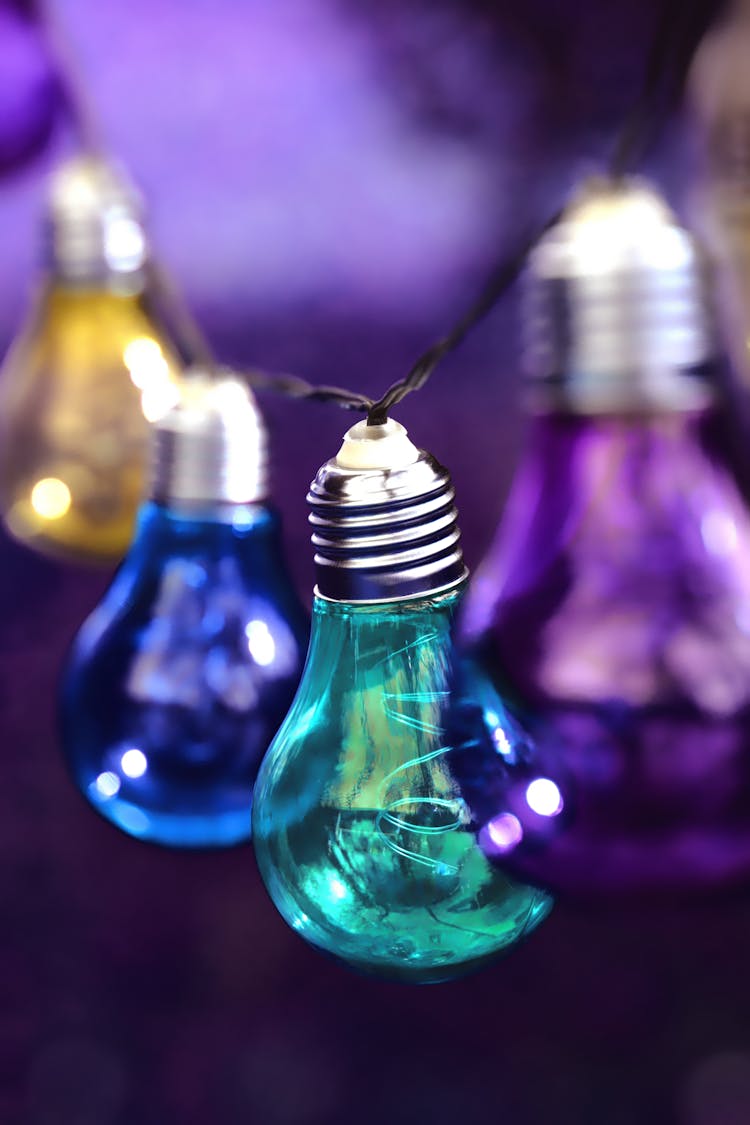 Purple, Teal, Blue, And Yellow Hanging Light Bulbs