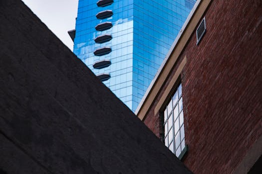 这张引人注目的图像捕捉到了香港现代玻璃摩天大楼与传统砖砌建筑的对比