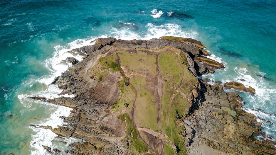 Explore the stunning rocky coastline of Crescent Head, Australia, captured from above.