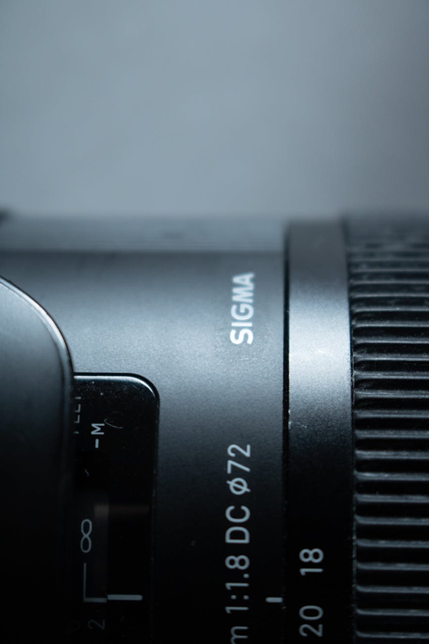 Detailed close-up of a Sigma camera lens showing focus and zoom features.