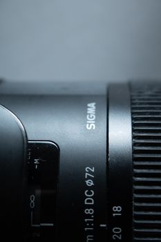 Detailed close-up of a Sigma camera lens showing focus and zoom features.