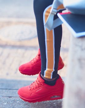 Stylish red sneakers worn outdoors, embodying leisure and fashion in Johannesburg.