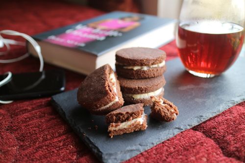 Free Enjoy homemade chocolate cookies with a glass of tea in a cozy setting. Stock Photo