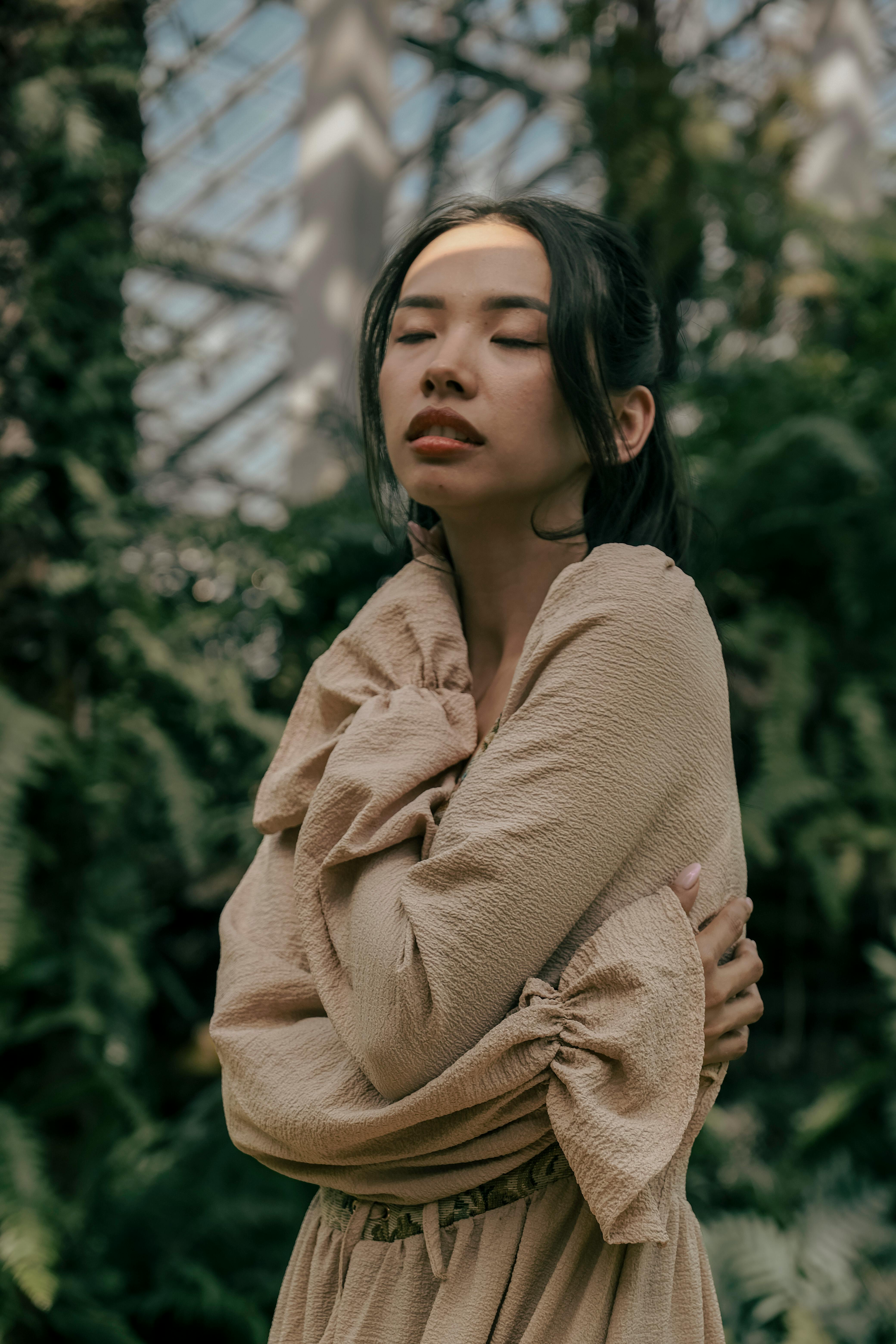 Woman with eyes closed in tropical background