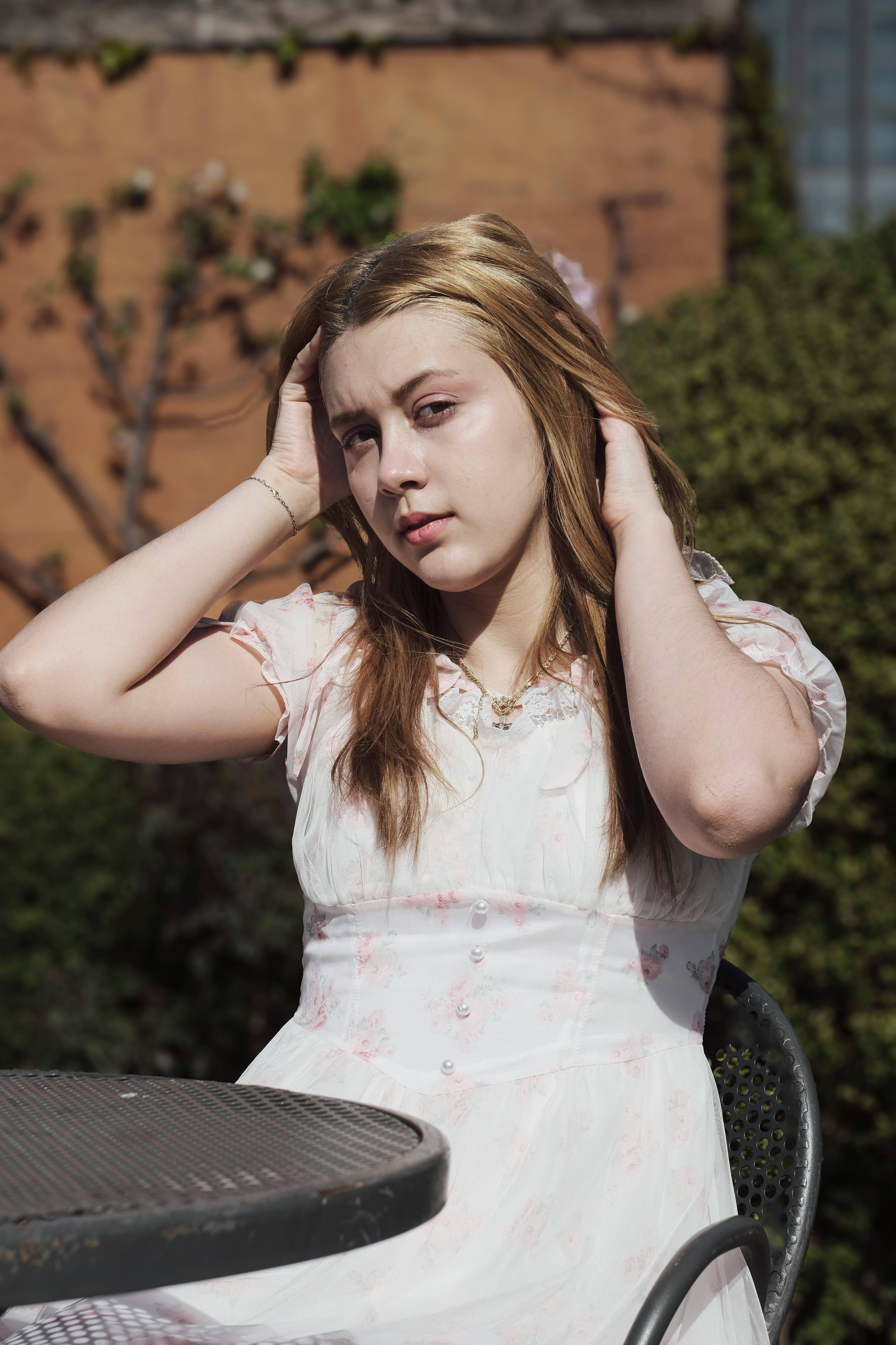 woman tossing hair sitting outside