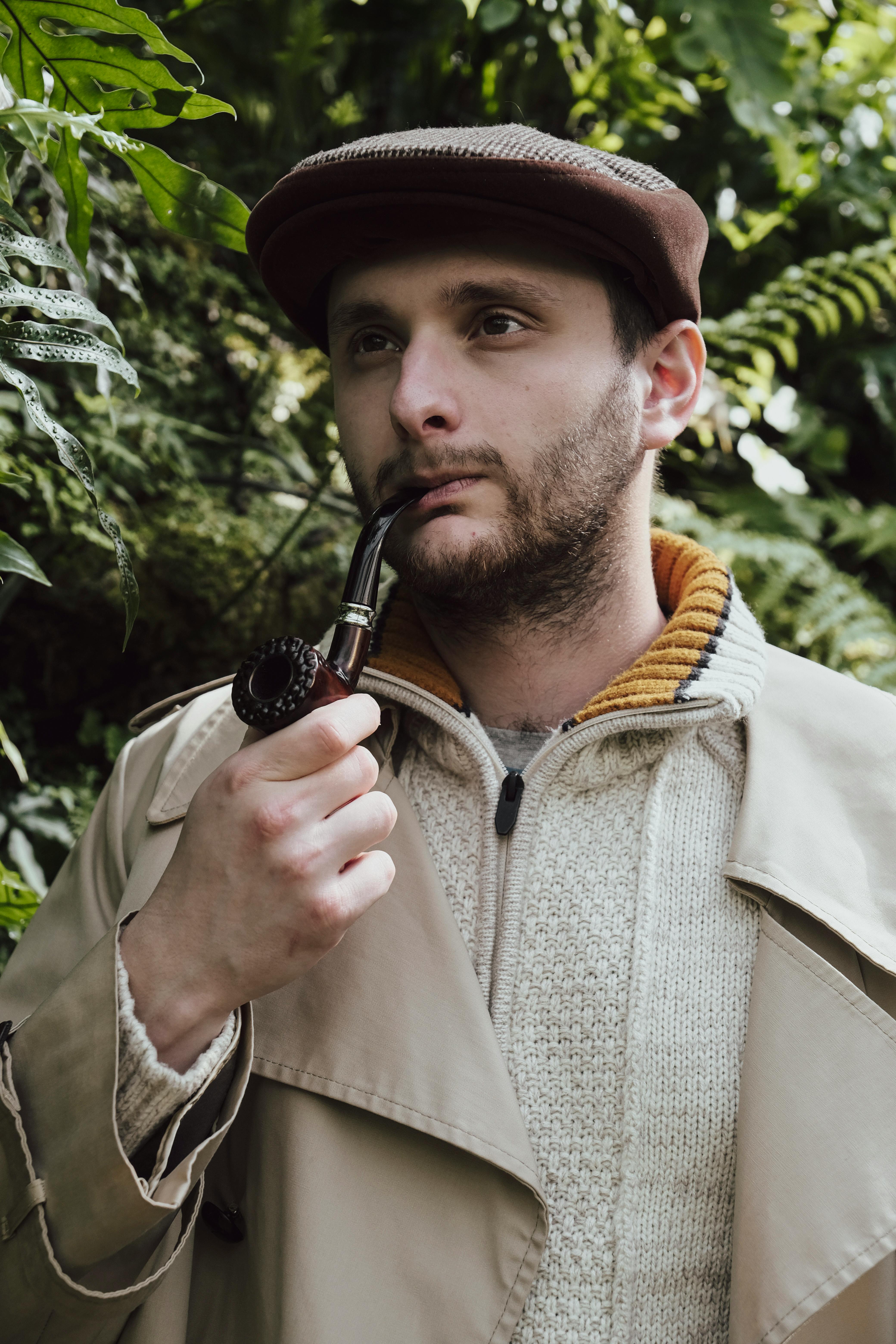 man in flat cap smoking a pipe