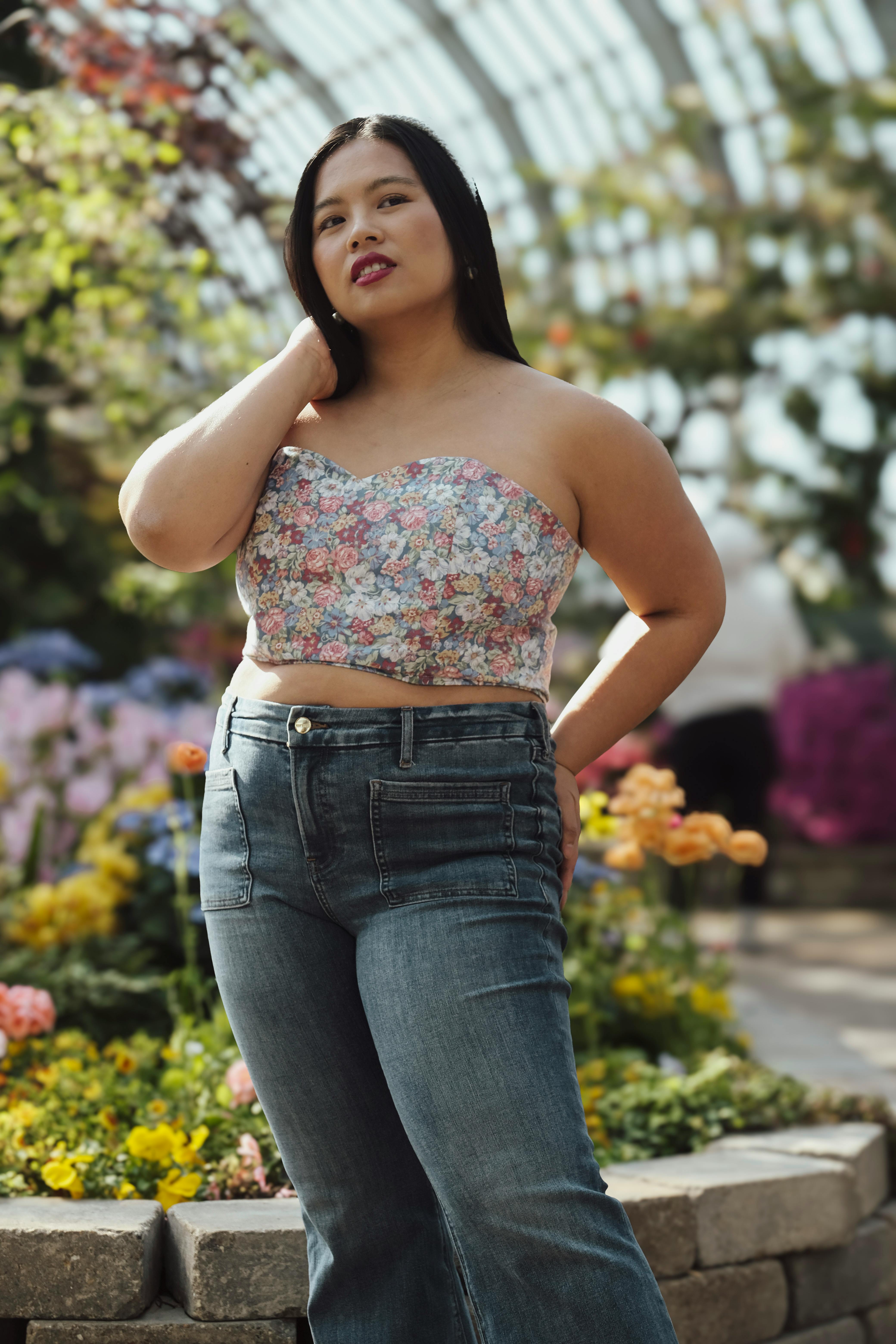 woman touching her neck in garden