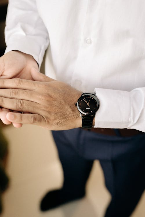 A man in a white shirt and black watch