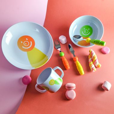 Children's tableware set with a smiling face design — photo by BuyFnB on Pexels