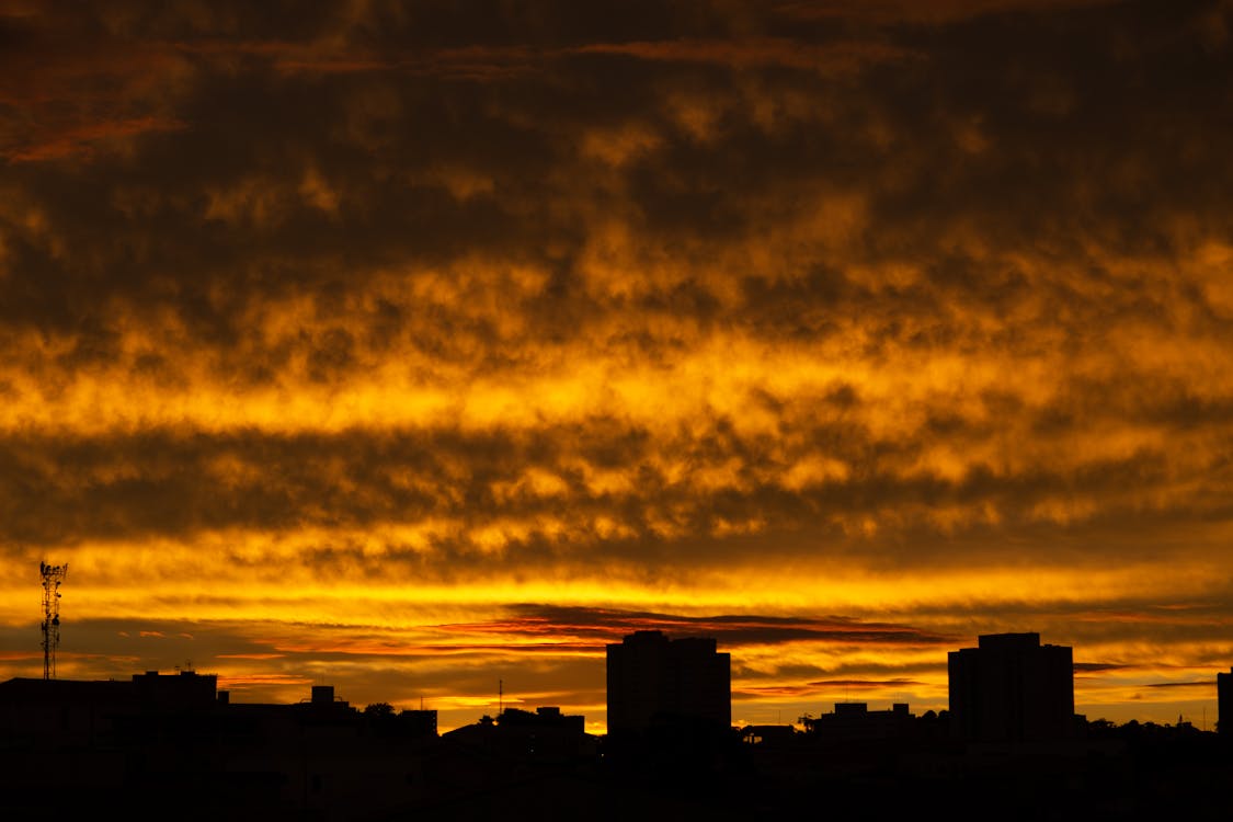Silhouette of Building Across Yellow Clouds Photo · Free Stock Photo