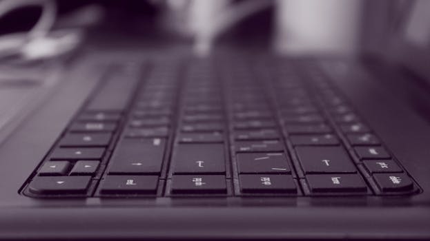 A black keyboard in focus, showcasing a shallow depth of field. Perfect for tech imagery.
