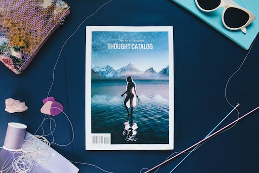 Creative flat lay featuring a Thought Catalog magazine with colorful threads and accessories.